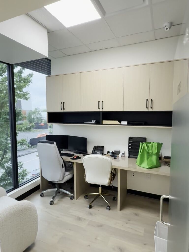 Medical clinic staff workstation with custom upper cabinets and built-in desk, commercial interior by RK Modern Construction