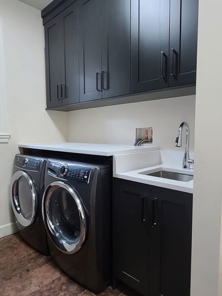 Laundry room with black shaker cabinets and quartz counter