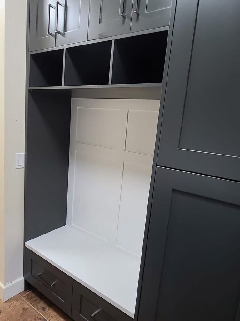 Mudroom built-in bench, cubbies and tall black storage cabinets